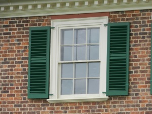 Window with louvered shutters.